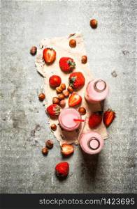 Strawberry juice with nuts on the old fabric. On the stone table.. Strawberry juice with nuts on the old fabric.