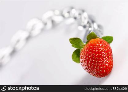 Strawberry laying on a white background among a chain. Strawberry imaginations