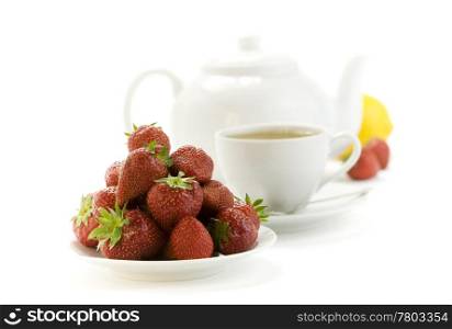 strawberry, lemon, teapot and white teacup with hot tea on white background