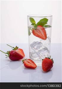 Strawberry lemonade with lemon and mint. Water detox. Mineral water with fruit frozen in ice cubes