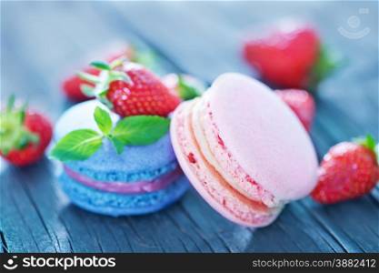 strawberry macaroons and fresh berries on a table