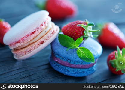 strawberry macaroons and fresh berries on a table