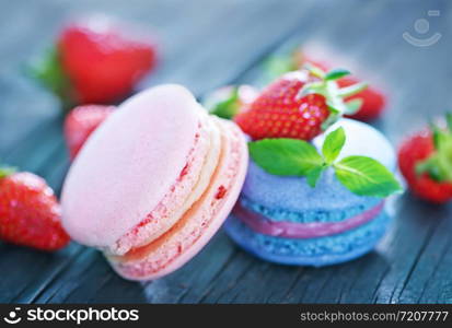 strawberry macaroons and fresh berries on a table