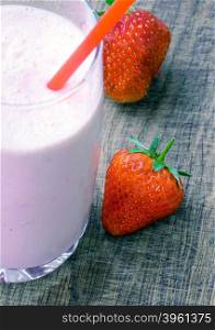 Strawberry milk shake with strawberries on wooden background, soft focus on strawbery