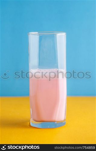 strawberry milkshake on a colored background