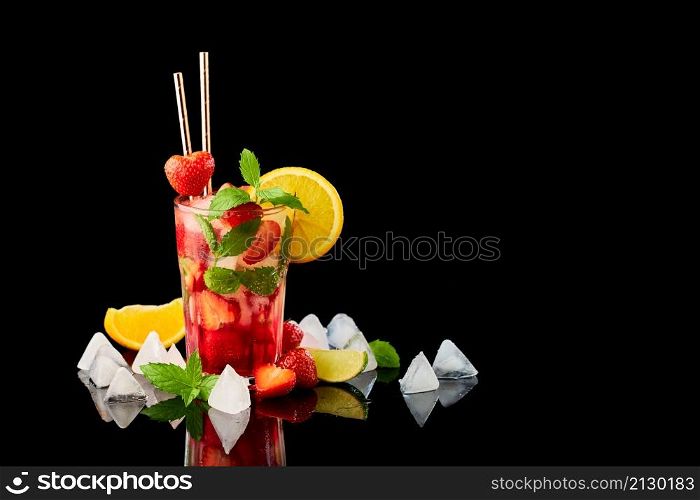 Strawberry mojito with lemon and mint isolated on black background with reflection.. Strawberry mojito with lemon and mint isolated on black background with reflection