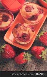 Strawberry muffins on the plate and berries. Strawberry muffins