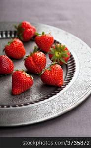 strawberry on vintage plate