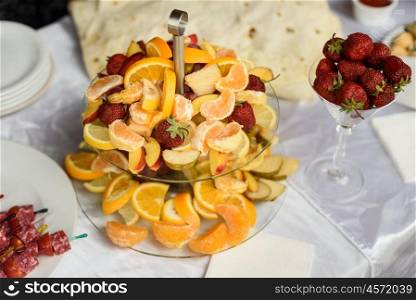 strawberry, orange, peach Mandarin. lemon. assorted fruit in a bowl