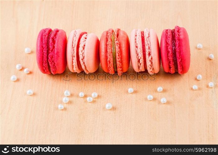 strawberry, raspberry and rhubarb macarons on wooden table