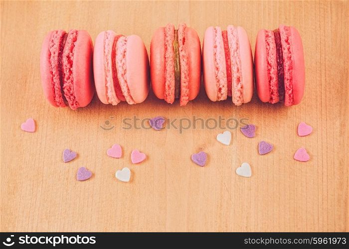 strawberry, raspberry and rhubarb macaroons on wooden table