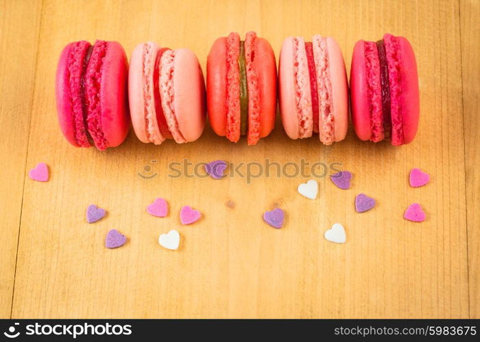 strawberry, raspberry and rhubarb macaroons on wooden table