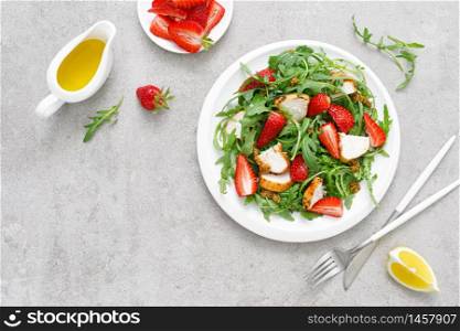 Strawberry salad with arugula and chicken meat