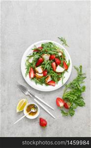 Strawberry salad with arugula and chicken meat