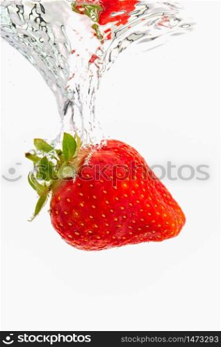 Strawberry sinking underwater with air bubbles isolated on white background. Antioxidant fruit theme.. Strawberry sinking underwater with air bubbles isolated on white background.