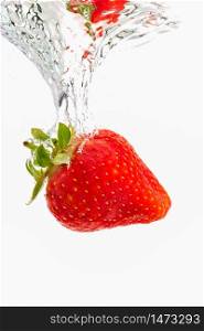 Strawberry sinking underwater with air bubbles isolated on white background. Antioxidant fruit theme.. Strawberry sinking underwater with air bubbles isolated on white background.