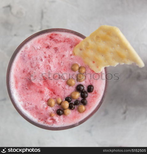 Strawberry smoothie with cookie. Strawberry smoothie with cookie on a white concrete background. Square cropping