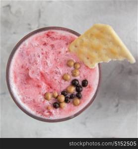 Strawberry smoothie with cookie. Strawberry smoothie with cookie on a white concrete background. Square cropping