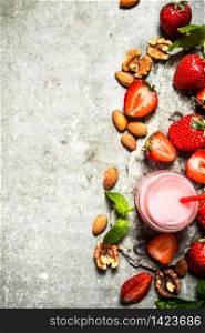 Strawberry smoothie with mint and nuts. On the stone table.. Strawberry smoothie with mint and nuts.