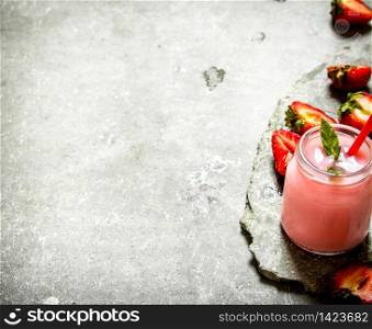 Strawberry smoothie with mint. On the stone table.. Strawberry smoothie with mint.