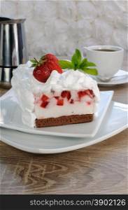 Strawberry souffle on a chocolate sponge cake with whipped cream