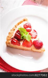 Strawberry tart with custard on the table