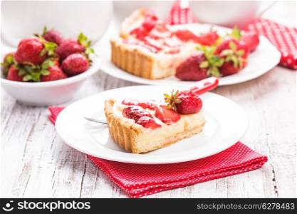 Strawberry tart with custard on the table