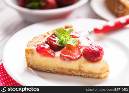 Strawberry tart with custard on the table. Strawberry tart