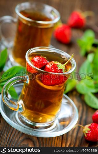 strawberry tea in cups and on a table