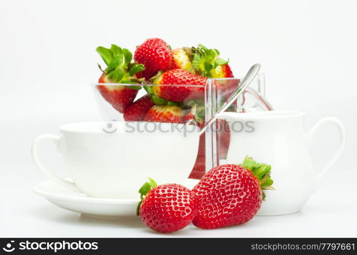 strawberry, white cup and teapot isolated on white