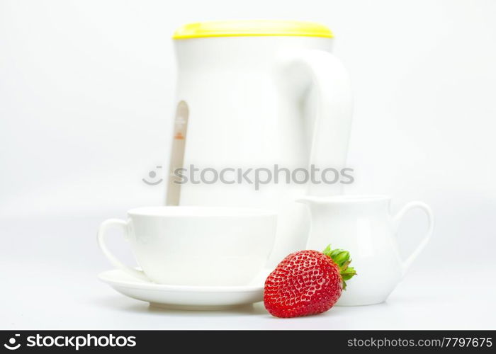 strawberry, white cup and teapot isolated on white