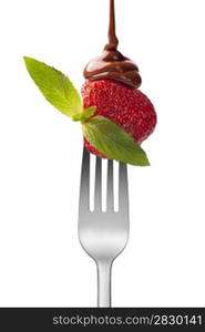 strawberry with chocolate and mint on the fork