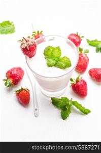 Strawberry yoghurt in glass on the white table