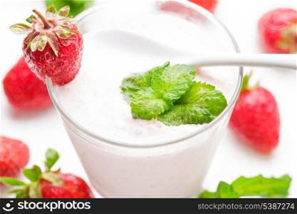 Strawberry yoghurt in glass on the white table