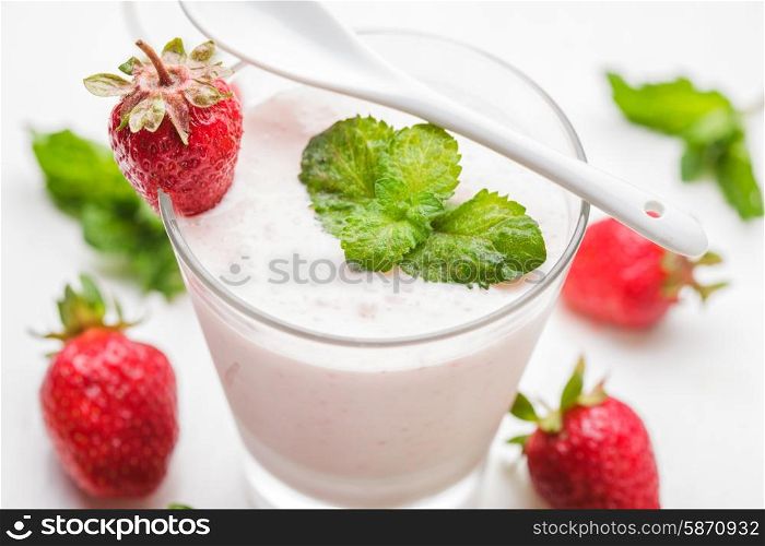 Strawberry yoghurt in glass on the white table. Strawberry yoghurt