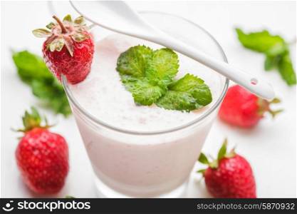 Strawberry yoghurt in glass on the white table. Strawberry yoghurt