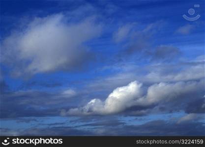 Streaking White And Gray Clouds In A Light Blue Sky