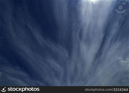 Streaks Of Cloud Wisps In A Dark Blue Sky
