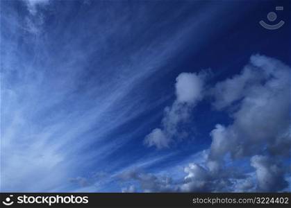 Streaks Of Clouds In A Deep Blue Sky