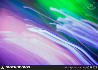 Streaks of light colored. Glowing abstract lines. Green, blue, purple and pink colors.