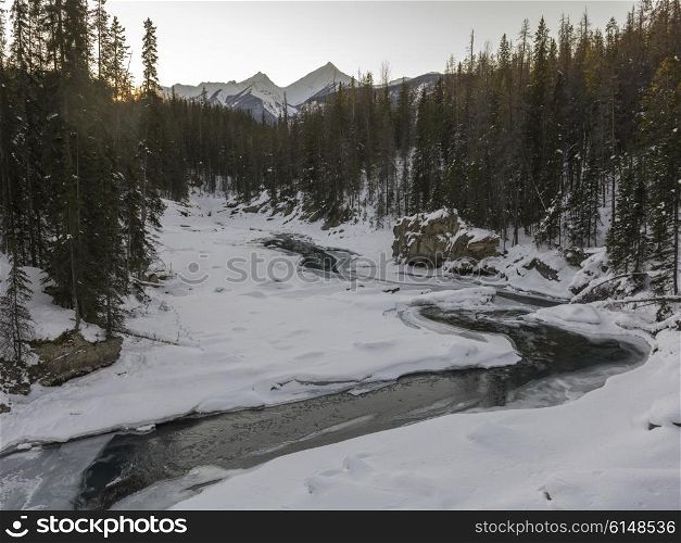 Stream flowing in snow covered valley in winter, Emerald Lake, Yoho National Park, British Columbia, Canada