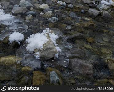 Stream flowing over rocks in winter, Lake Louise, Banff National Park, Alberta, Canada