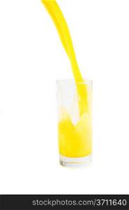 stream of orange juice flows in glass