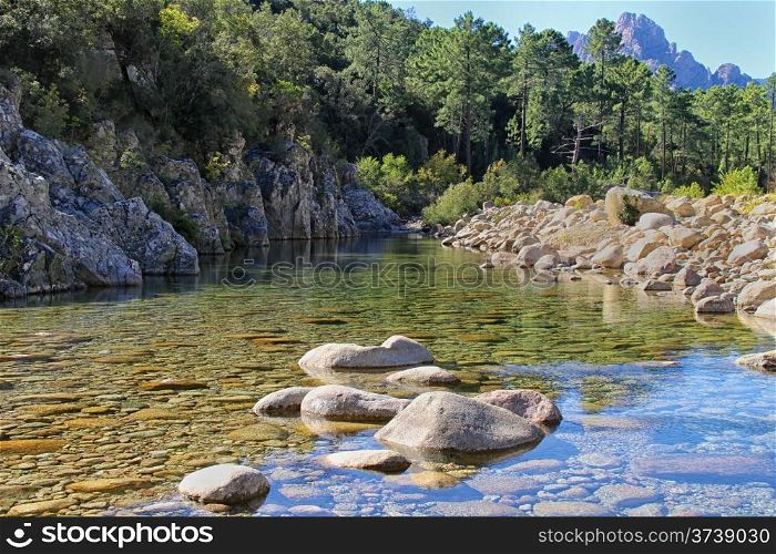Stream, rocks, trees and Mountains at Col de Bavella, Corsica