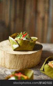 Streamed pork curry in a banana leaf cup. 