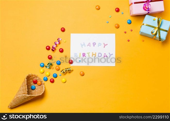streamers gems waffle with happy birthday paper against yellow background