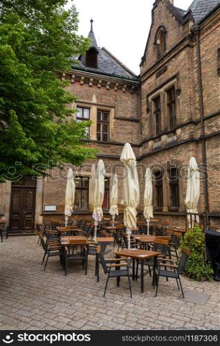 Street cafe in ancient European town, nobody. Summer tourism and travels, famous europe landmark, popular places. Street cafe in ancient European town, nobody