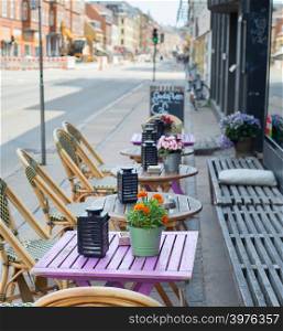 Street cafe near the road. Copenhagen, Denmark