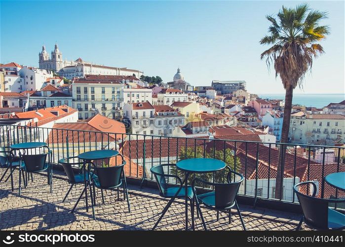 Street cafe table with city skyline view. Lisbon, Alfama district, Portugal