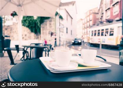 Street cafe table with two cups of coffee